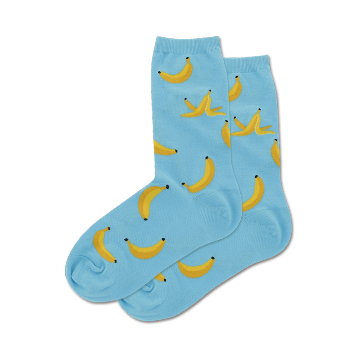 Pair of light blue crew socks with a whimsical pattern of yellow bananas and banana peels. }}