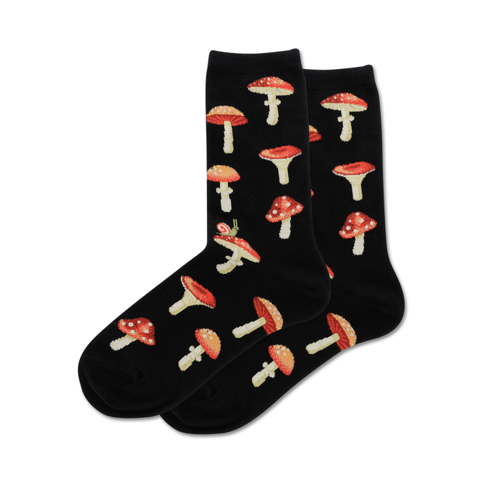 Pair of crew socks in black with a repeating pattern of red and white mushrooms and a small snail.