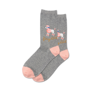 Lifestyle shot showing a pair of grey 'Fancy Bitch' socks with pink accents on a model's feet.