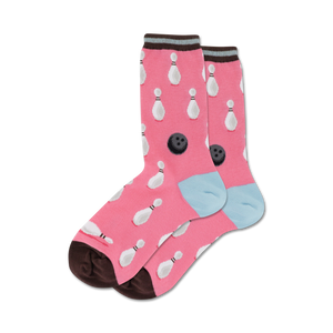Pair of pink crew socks with white bowling pins and black bowling balls pattern. Brown and light blue cuffs.