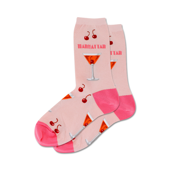 Pair of pink crew socks with a Manhattan cocktail print. Features orange cocktails, red cherries, and pink accents. }}