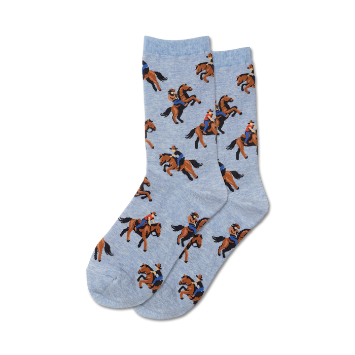 Pair of light blue crew socks with a pattern of cowboys riding brown horses. A fun, western-themed design. }}