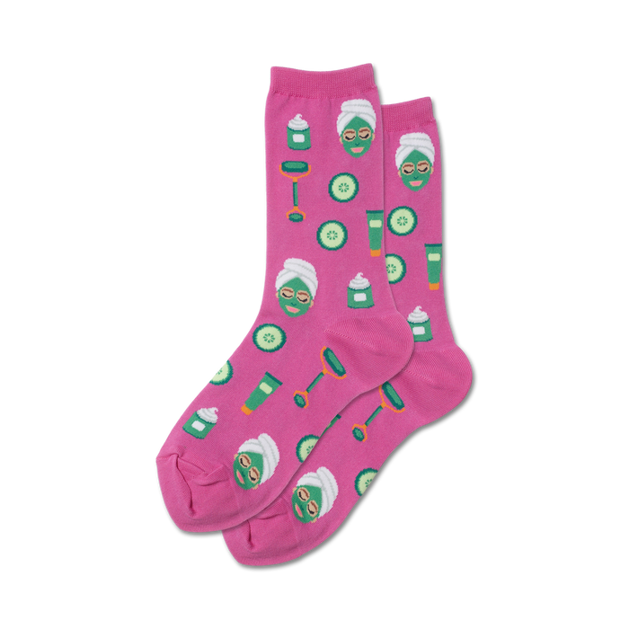 Pair of pink crew socks with a fun spa-themed design:  facial masks, cucumbers, and beauty products.