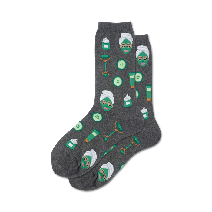 womens crew socks featuring a relaxing spa-themed pattern of gray, green facial masks, jade rollers, and cucumber slices.  