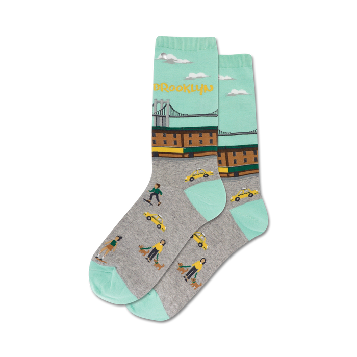 Pair of crew socks with a teal and gray design. Features a Brooklyn bridge image, yellow cabs, and pedestrians. }}
