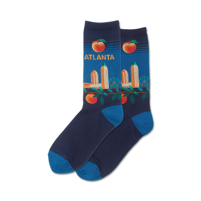 Pair of crew socks in navy blue with an Atlanta skyline design. Peaches and a Ferris wheel are also featured on the socks in orange and green. }}