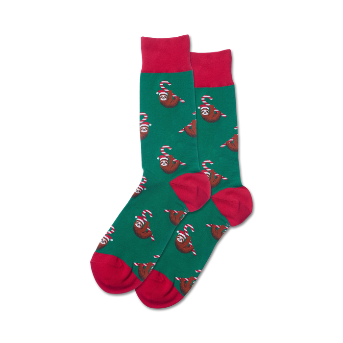 mens green crew socks with pattern of sloths wearing santa hats and holding candy canes. red toe, heel, and top.   