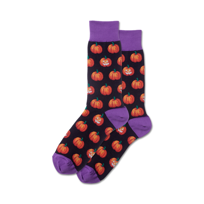 Pair of crew socks with a dark background and orange grinning pumpkin pattern. Purple cuffs. }}