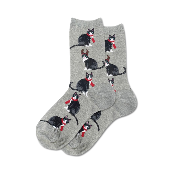 Pair of grey crew socks with repeating pattern of black and white tuxedo cats wearing red scarves and some with antlers. }}