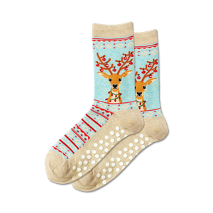 womens fuzzy light blue crew slipper socks with a red and white snowflake pattern. red and brown reindeer wearing a green and red striped scarf with a red ball on the end.  