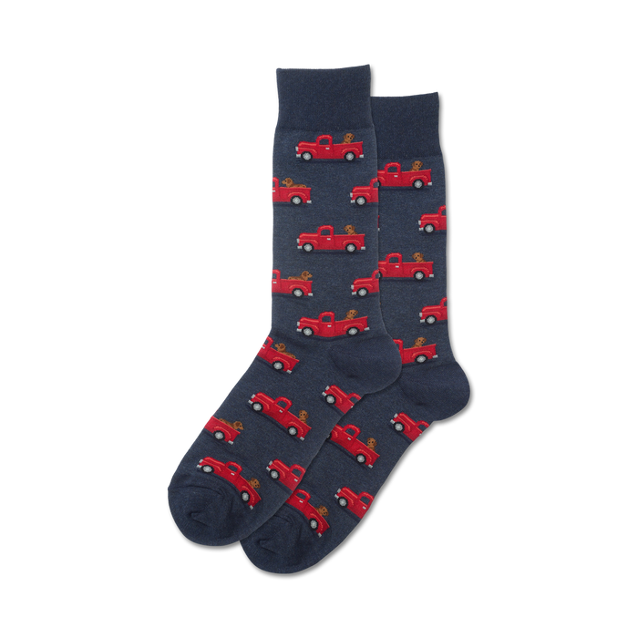 Pair of navy blue crew socks with a repeating pattern of red pickup trucks carrying small brown dogs. }}