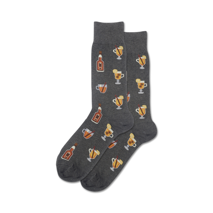 Pair of dark grey crew socks with a repeating pattern of illustrated mugs of hot toddies, bottles, cinnamon sticks, and lemon slices. }}