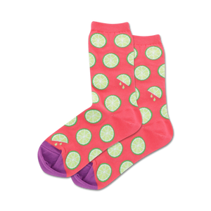 Pair of crew socks; coral pink with lime slices and purple heel and toe; orange socks in light blue with orange slices and mint green heel and toe.