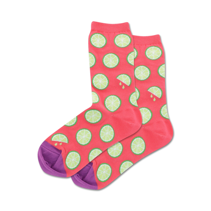Pair of crew socks; coral pink with lime slices and purple heel and toe; orange socks in light blue with orange slices and mint green heel and toe.