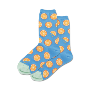 Lifestyle shot of a person wearing the orange citrus socks, showing them styled with a summery outfit.