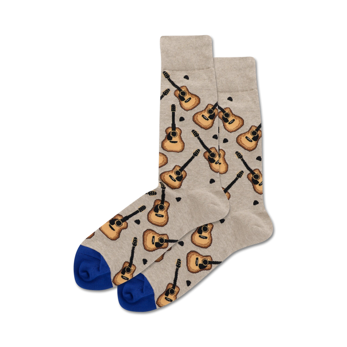 Pair of beige crew socks with repeated acoustic guitar pattern and royal blue cuffs. }}