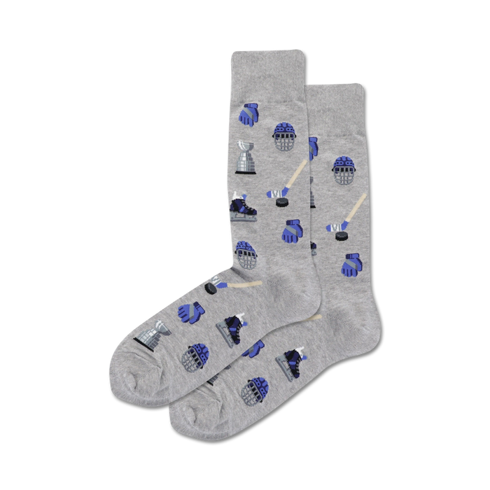 Flatlay image showing a pair of grey crew socks with a hockey-themed pattern. The pattern includes hockey sticks, pucks, goalie masks, and skates in blue.