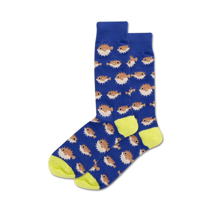 Pair of crew socks featuring a repeating pattern of brown pufferfish on a blue background with neon yellow cuffs. }}