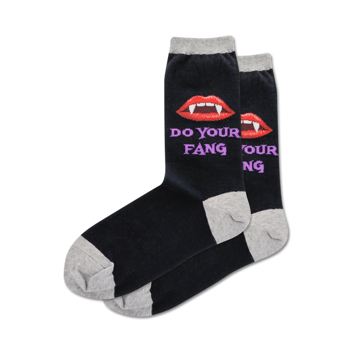 Pair of black crew socks with a grey cuff.  Features a red vampire lip design and the text 'Do Your Fang' in purple. }}