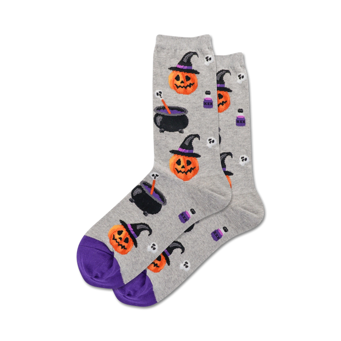 Pair of grey crew socks with purple cuffs. Features a whimsical Halloween design: witch pumpkins, cauldrons, potion bottles, and skulls.