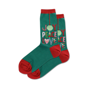 Pair of teal crew socks with red cuffs. Features a colorful 'Joy Peace Love' design incorporating Christmas ornaments and trees.