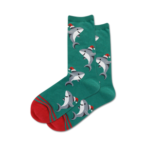 Pair of crew socks; teal and red or light blue and navy; design features sharks wearing Santa hats.