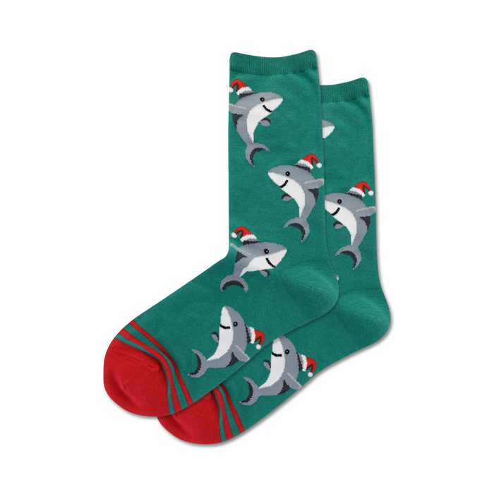 Pair of crew socks; teal and red or light blue and navy; design features sharks wearing Santa hats.