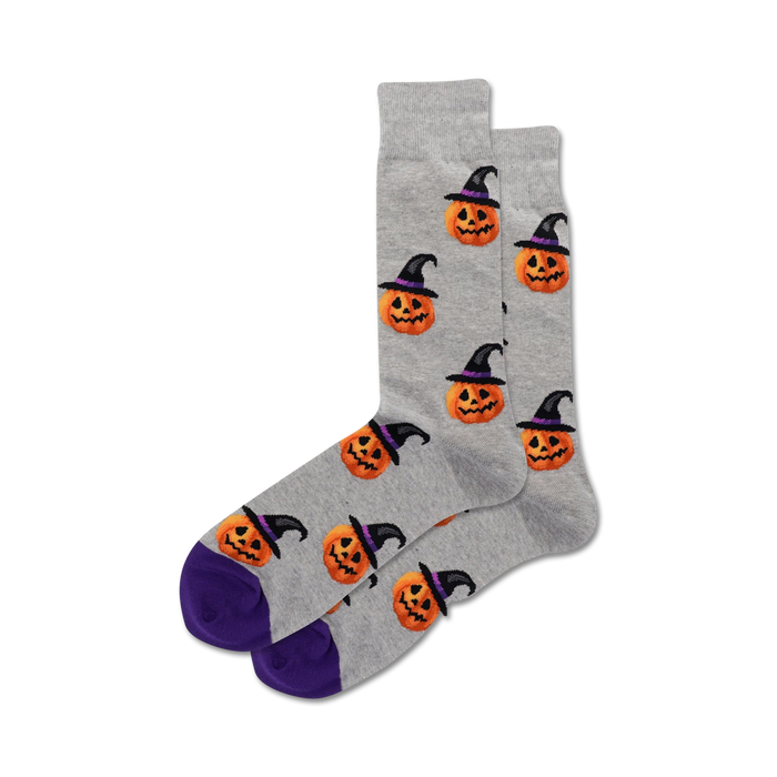 gray crew socks with all-over pattern of cartoon pumpkin heads wearing witch hats; perfect for halloween fun.   }}