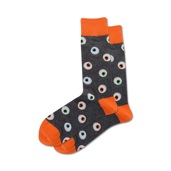 Pair of grey crew socks with orange cuffs and a repeating eyeball pattern. The eyeballs are multicolored with black pupils.