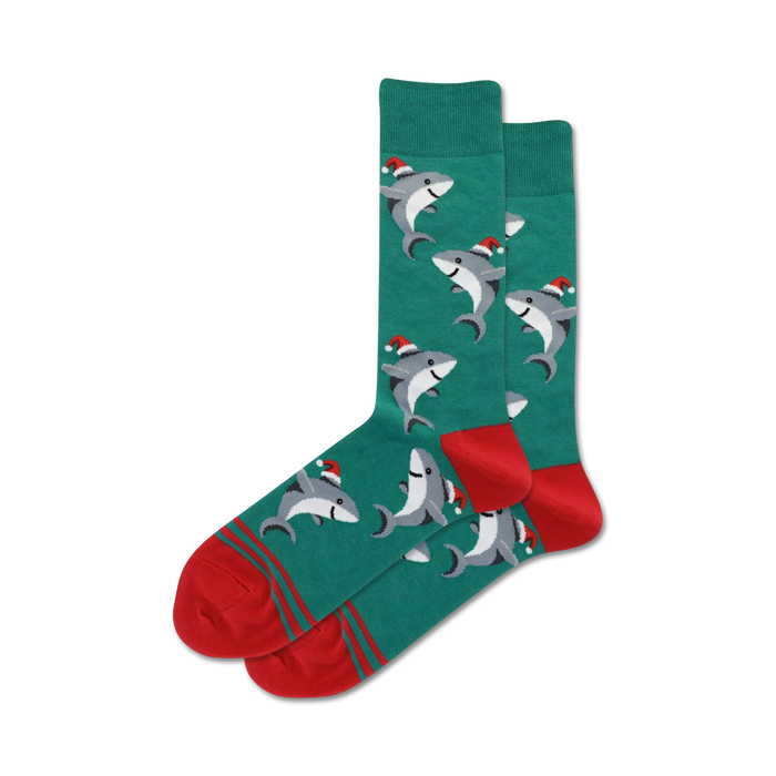 Pair of teal crew socks with a pattern of gray sharks wearing Santa hats. Red and teal stripes at the cuff.