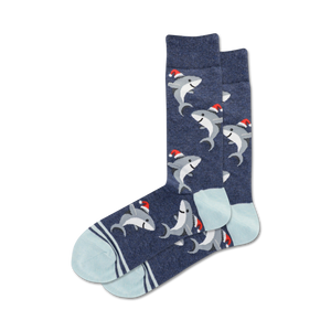 Pair of navy blue crew socks with a pattern of gray sharks wearing Santa hats. Light blue and navy stripes at the cuff.