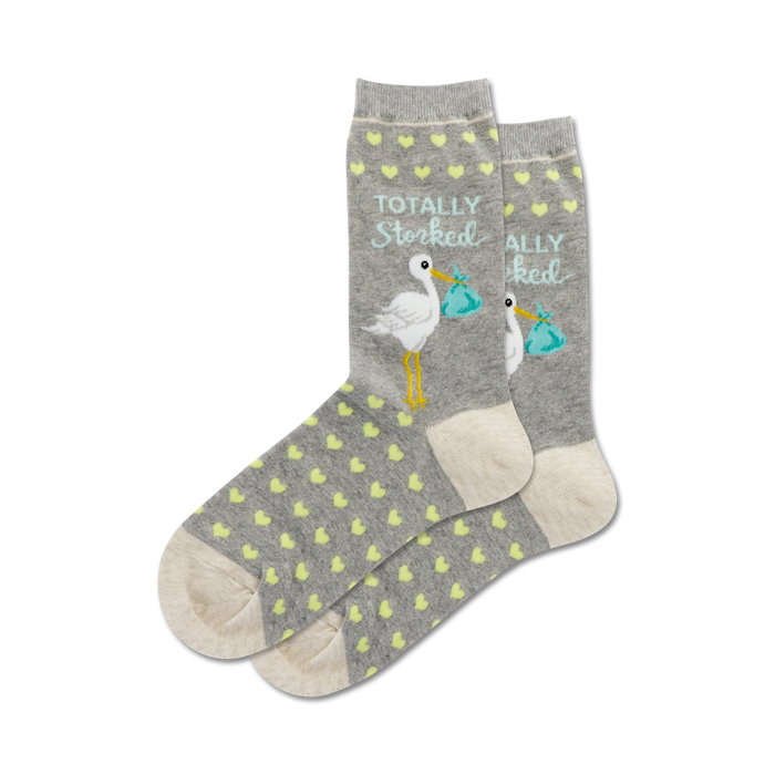 A close-up flatlay product shot showing a pair of grey 'Totally Storked' socks with pale yellow hearts.