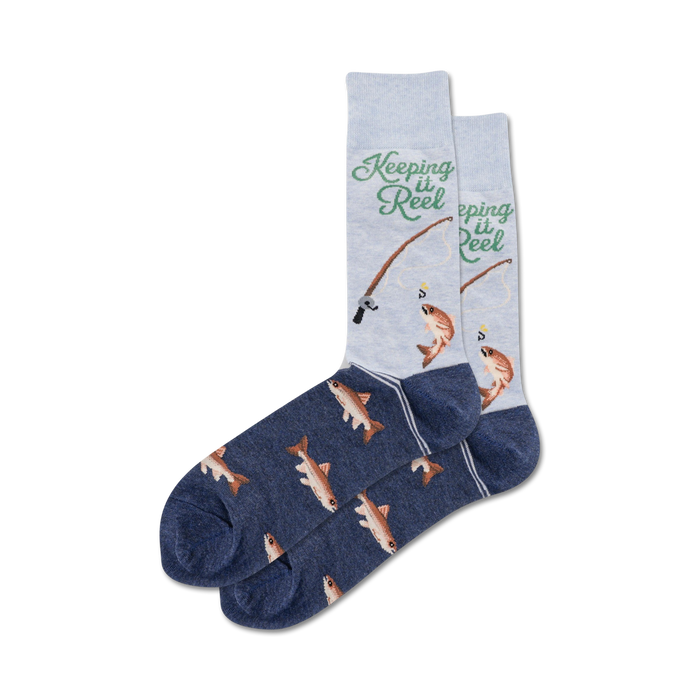 Pair of crew socks, navy blue and light grey, featuring a fishing-themed design with fish illustrations and the text 'Keeping it Reel'.