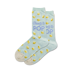 Lifestyle shot: A person's feet wearing the light blue 'Ready to Pop' popcorn socks.