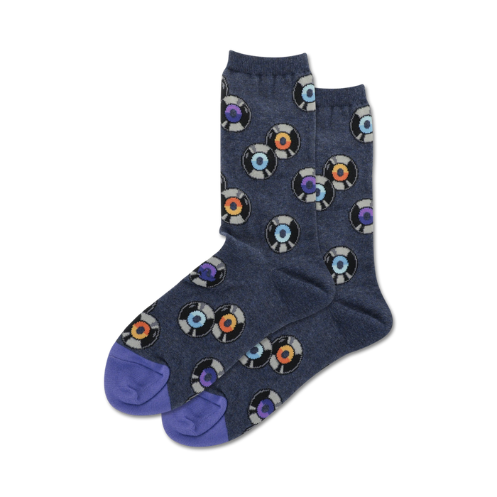 Pair of crew socks, navy blue with multicolored vinyl record designs, purple heel and toe.