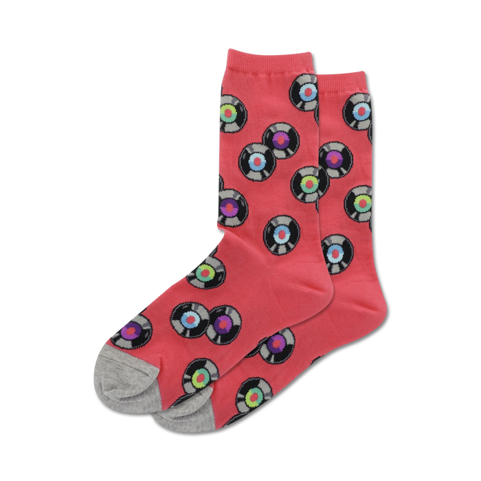 Lifestyle shot showing coral colored 'Records' socks with grey heel and toe. The socks feature a fun pattern of multicolored vinyl records.