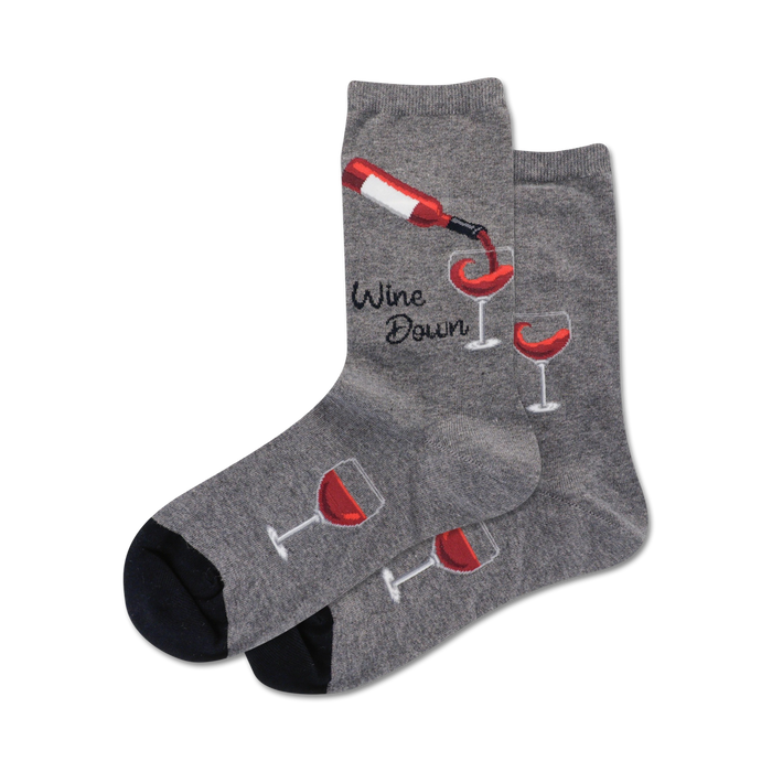 Pair of crew socks in grey and navy blue.  Design features wine bottles pouring into glasses and the text 'Wine Down'.