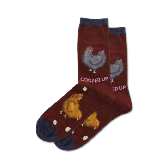 Pair of maroon crew socks with a navy cuff. Features illustrations of chickens and eggs. Text reads 'Cooped Up'.