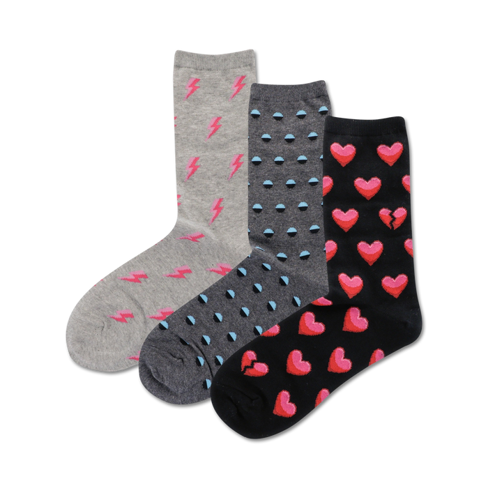 Three pairs of crew socks: gray with pink lightning bolts, gray with teal polka dots, and black with pink whole and broken hearts. }}