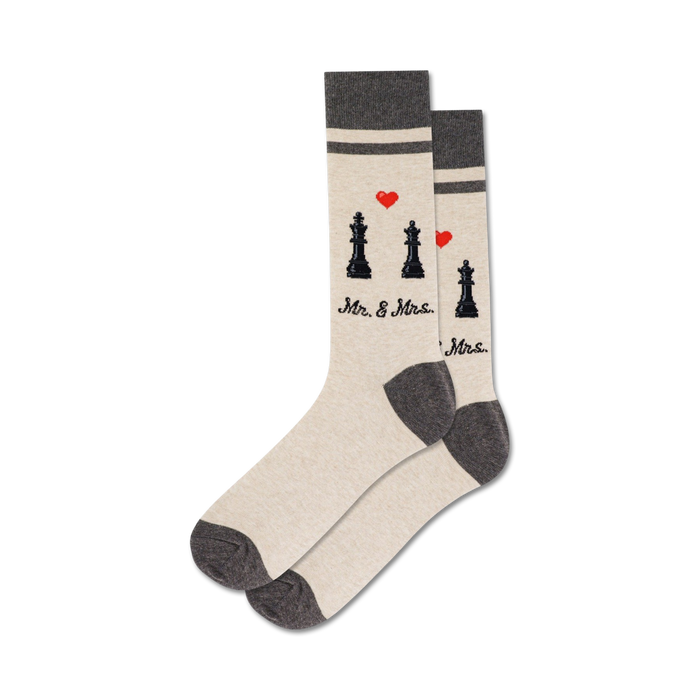 light gray socks with black and red accents feature a pattern of chess pieces, hearts, and stripes, plus the words 