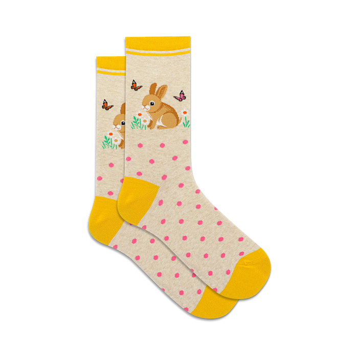 socks that are white with yellow stripes at the top and yellow toes and heels. there are pink polka dots all over the socks. there is a pattern of rabbits holding flowers in their paws and there are butterflies all around them. }}