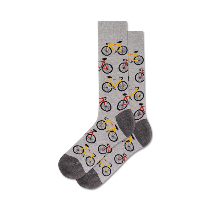 A pair of grey crew socks with a repeating pattern of yellow and red bicycles.  }}