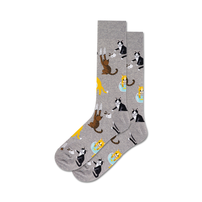 Pair of crew socks in grey and blue, featuring a repeating pattern of cute cats drinking from coffee cups and hanging off mugs.