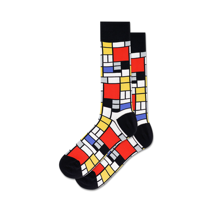 Pair of crew socks in red, yellow, black, and blue, featuring a Mondrian-inspired geometric design. }}