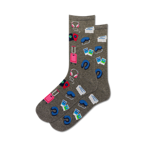Pair of gray crew socks with colorful travel icons: suitcase, passport, headphones, sleep mask.  Perfect for wanderlusters!