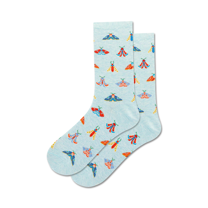 Lifestyle shot showing a pair of light blue crew socks with a moth pattern on a neutral background.