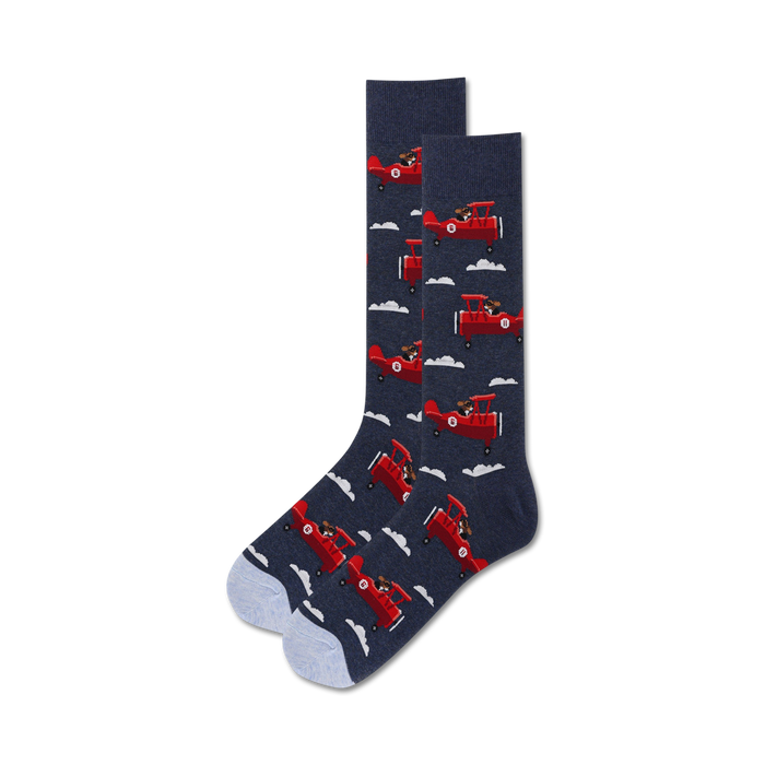 Pair of crew socks; navy blue with red airplanes and dogs; light blue sole.