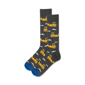 Close-up of a pair of gray crew socks with yellow airplanes and dogs; blue sole.