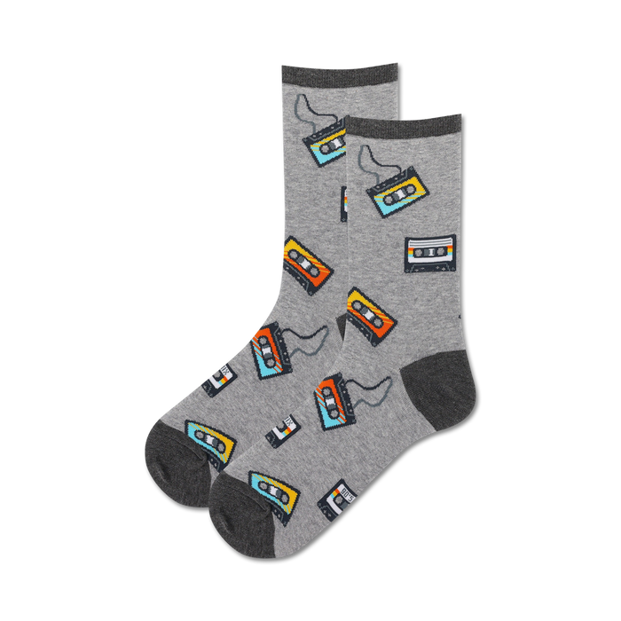 Pair of grey crew socks with colorful retro cassette tape designs. The tapes are orange, yellow, and blue. }}