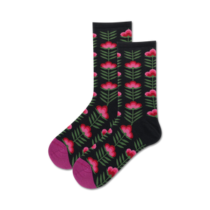 Pair of black crew socks with a retro pink and green floral pattern.  Features a magenta-colored toe and heel.